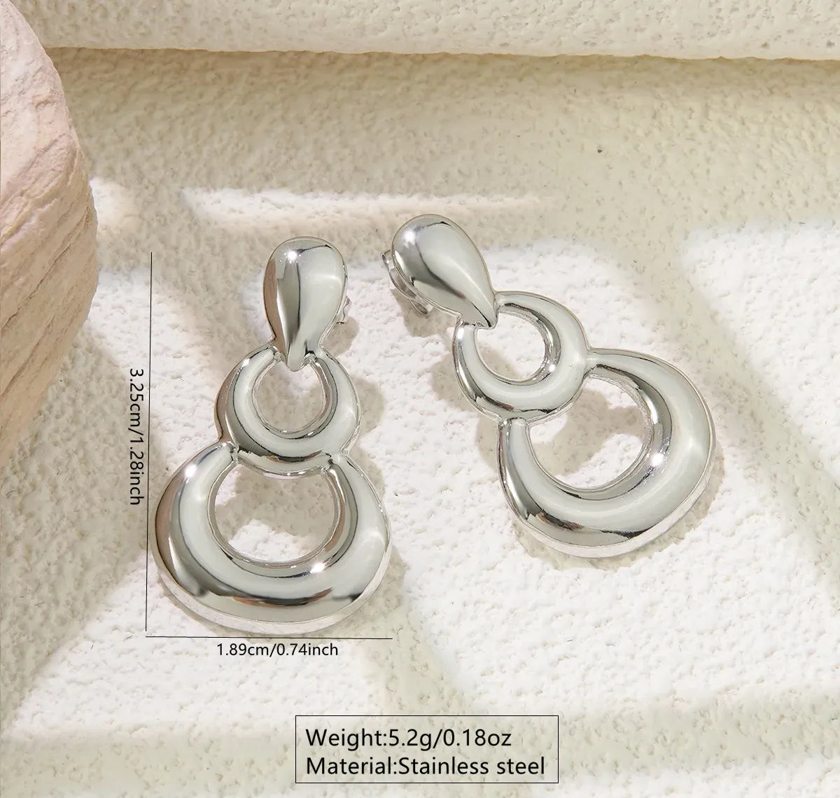 Aretes plateados con gota y dos aros
